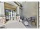 Inviting front porch with chairs and decorative stone accents at 13028 Grant W Cir # A, Thornton, CO 80241