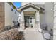 Charming front porch featuring stone pillars and outdoor seating at 13028 Grant W Cir # A, Thornton, CO 80241