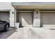 Garages and driveway with space for cars, with a modern exterior and lighting fixtures at 13028 Grant W Cir # A, Thornton, CO 80241