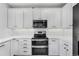 Modern kitchen with white cabinets, stainless steel appliances, and subway tile backsplash at 13028 Grant W Cir # A, Thornton, CO 80241