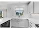 White kitchen with white cabinetry, quartz countertops, stainless steel appliances, and a view out of the window at 13028 Grant W Cir # A, Thornton, CO 80241