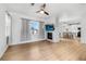 Bright living room with a fireplace, ceiling fan, and wood floors at 13028 Grant W Cir # A, Thornton, CO 80241