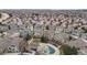 Expansive aerial view of a residential neighborhood with community pool and well-maintained landscaping at 1311 Carlyle Park Cir, Highlands Ranch, CO 80129