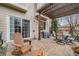 Inviting backyard patio with brick pavers, featuring outdoor seating and a grill at 1311 Carlyle Park Cir, Highlands Ranch, CO 80129