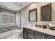 Modern bathroom with a glass-enclosed shower, vanity with dark cabinetry, and neutral tones at 1311 Carlyle Park Cir, Highlands Ranch, CO 80129