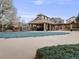 View of a community pool covered with a tarp and a pergola with stone and brick pillars at 1311 Carlyle Park Cir, Highlands Ranch, CO 80129