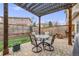 Cozy covered patio featuring pavers, dining set, and a well-maintained yard at 1311 Carlyle Park Cir, Highlands Ranch, CO 80129