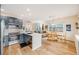 Bright kitchen featuring stainless steel appliances, blue cabinets, and an island with a quartz countertop and seating at 1311 Carlyle Park Cir, Highlands Ranch, CO 80129