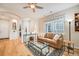Inviting living room with hardwood floors, featuring archways and plenty of natural light at 1311 Carlyle Park Cir, Highlands Ranch, CO 80129