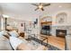The open-concept home features a living room with fireplace adjacent to the dining area at 1311 Carlyle Park Cir, Highlands Ranch, CO 80129