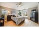 Spacious main bedroom featuring a ceiling fan, large window, and neutral decor creating a relaxing atmosphere at 1311 Carlyle Park Cir, Highlands Ranch, CO 80129