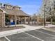 Community pool entrance with landscaped walkway and building offering shaded space at 1311 Carlyle Park Cir, Highlands Ranch, CO 80129