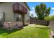 Backyard view showcasing an elevated deck, green lawn, and partial fencing, offering a private outdoor space at 5154 E 126Th Ct, Thornton, CO 80241