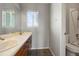 Bathroom with double sinks, wood cabinets, and a toilet at 5154 E 126Th Ct, Thornton, CO 80241