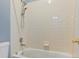 Clean bathroom with tub shower combination and tiled walls at 5154 E 126Th Ct, Thornton, CO 80241