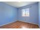 Light and bright bedroom with wood floors and a window offering natural light at 5154 E 126Th Ct, Thornton, CO 80241