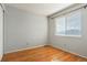 Simple bedroom with hardwood floors and window with blinds at 5154 E 126Th Ct, Thornton, CO 80241