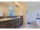 Bathroom featuring double sinks, mosaic tile backsplash, and a shower and soaking tub combo at 9523 Gray Ct, Westminster, CO 80031
