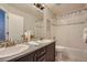 Bright bathroom featuring a double sink vanity with a bathtub-shower combo at 9523 Gray Ct, Westminster, CO 80031