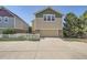 Charming home exterior features a two-car garage, well-manicured lawn, and beautiful landscaping for curb appeal at 9523 Gray Ct, Westminster, CO 80031