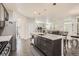 Open concept kitchen with island, stainless appliances, and view of living room, dining area and stairway at 9523 Gray Ct, Westminster, CO 80031