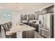 Spacious kitchen with stainless steel appliances, a large island with a marble countertop, and pendant lighting at 9523 Gray Ct, Westminster, CO 80031