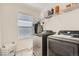 Functional laundry room with modern washer and dryer, practical shelving, and ample storage space to keep your home organized at 9523 Gray Ct, Westminster, CO 80031