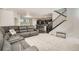 Open-concept living room with view to kitchen, modern staircase, and comfortable seating at 9523 Gray Ct, Westminster, CO 80031