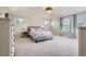 Spacious main bedroom featuring a tray ceiling, large windows, and neutral décor at 9523 Gray Ct, Westminster, CO 80031