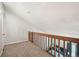 View from carpeted attic overlooking a bedroom with a bed and lamps at 9797 E Peakview Ave # C10, Englewood, CO 80111