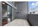 This is a relaxing balcony with string lights, a sliding glass door, and stone accents at 9797 E Peakview Ave # C10, Englewood, CO 80111