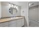 Bright bathroom with a round mirror, white cabinets and shower-tub combo at 9797 E Peakview Ave # C10, Englewood, CO 80111