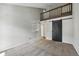 Neutral bedroom boasts plush carpet, a loft area, and sliding barn door at 9797 E Peakview Ave # C10, Englewood, CO 80111