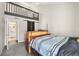 Bedroom featuring grey carpet, blue bedding and a sliding barn door at 9797 E Peakview Ave # C10, Englewood, CO 80111