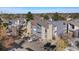 Aerial view of a multi-story building with parking spots and mature trees, complemented by natural stone accents at 9797 E Peakview Ave # C10, Englewood, CO 80111