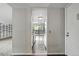Hallway view showcasing the kitchen, natural light, and spiral staircase at 9797 E Peakview Ave # C10, Englewood, CO 80111