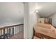 Hallway with brown wood banister and boxes on the floor at 9797 E Peakview Ave # C10, Englewood, CO 80111