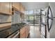 Updated kitchen with stainless appliances, granite counters, and access to the outdoor deck at 9797 E Peakview Ave # C10, Englewood, CO 80111
