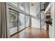 Sun-filled living room features a spiral staircase, tall ceilings, and balcony access at 9797 E Peakview Ave # C10, Englewood, CO 80111