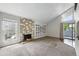 Living room features a stone fireplace, plush carpet, and a balcony at 9797 E Peakview Ave # C10, Englewood, CO 80111