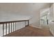 The carpeted loft with railing and access to the downstairs creates a unique view and feel to the space at 9797 E Peakview Ave # C10, Englewood, CO 80111