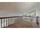 Spacious loft area featuring a vaulted ceiling, large windows, brown carpet, and railing at 9797 E Peakview Ave # C10, Englewood, CO 80111