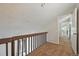Loft with carpet, natural lighting, and railing with a view of the entryway and staircase at 9797 E Peakview Ave # C10, Englewood, CO 80111