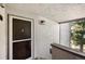 Exterior view of porch with textured walls and a glass storm door at 9797 E Peakview Ave # C10, Englewood, CO 80111