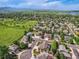 Expansive aerial view of a suburban neighborhood featuring lush green spaces and manicured lawns at 12693 W 82Nd Ln, Arvada, CO 80005