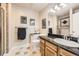 Bathroom featuring a vanity with granite counters, tiled flooring, and a glass enclosed shower at 12693 W 82Nd Ln, Arvada, CO 80005