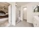 Bright bathroom featuring a shower room with black and white tiling design and a doorway to the bedroom at 12693 W 82Nd Ln, Arvada, CO 80005