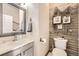 Stylish half bath with a nautical theme, white stone counters, vessel sink, and a decorative mirror at 12693 W 82Nd Ln, Arvada, CO 80005