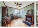 Home office with built-in bookshelves, fireplace, wood floors, and views of the outside at 12693 W 82Nd Ln, Arvada, CO 80005