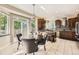 View of the kitchen from the breakfast nook with granite counters, tile backsplash, and stainless hood at 12693 W 82Nd Ln, Arvada, CO 80005